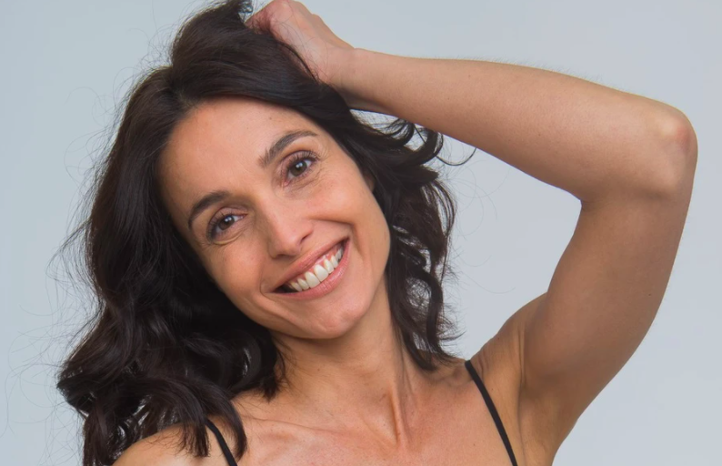 Woman smiling and holding hair